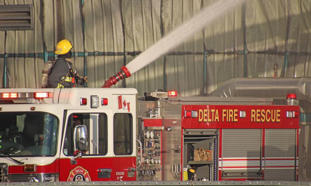 Firefighting apparatus with firefighter in action.