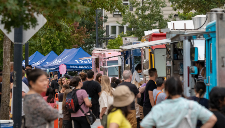People lined up at food trucks at the Luminary Festival.