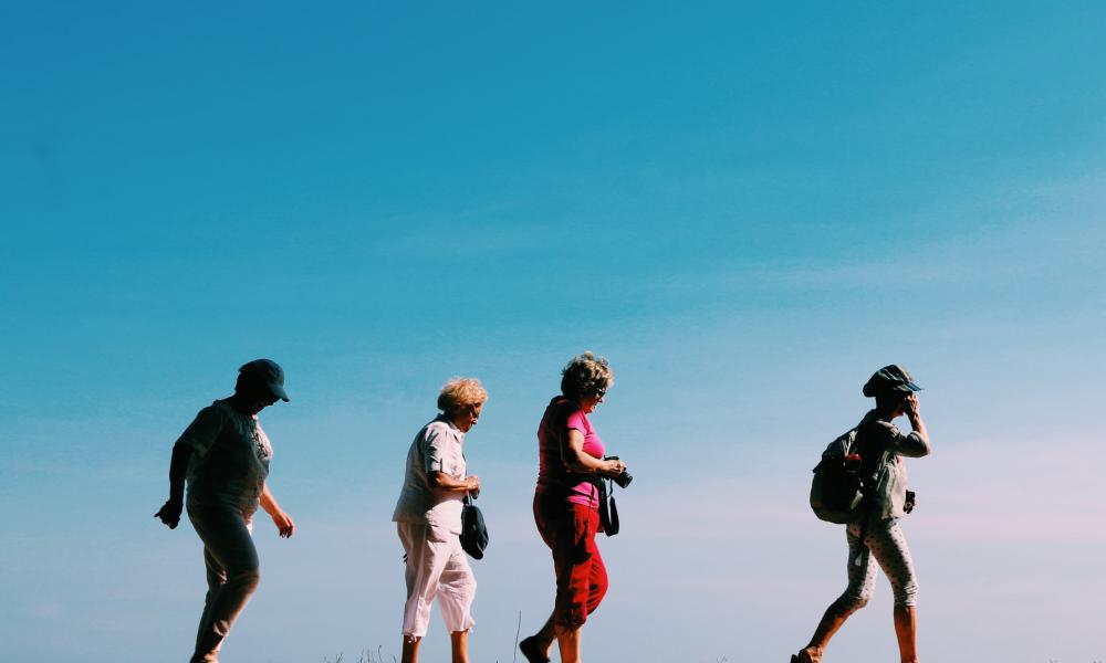 Four elderly women walking