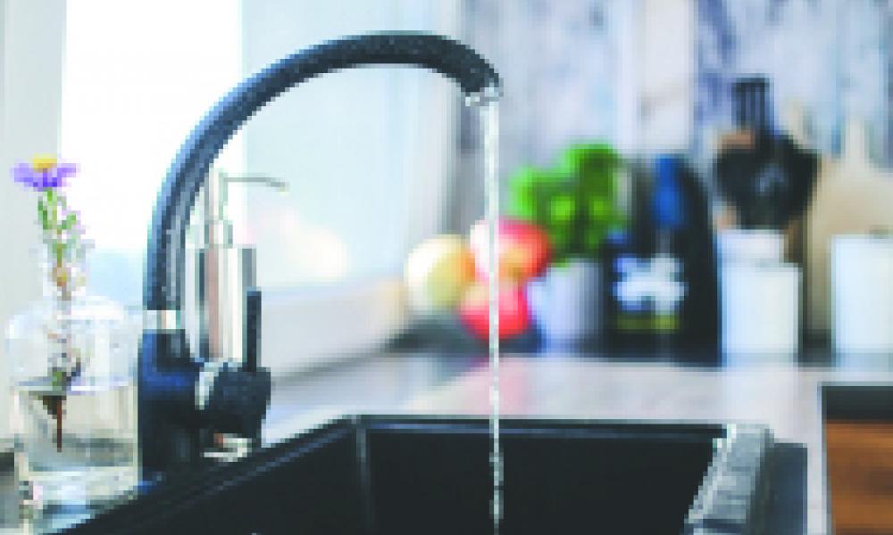 A kitchen faucet running water