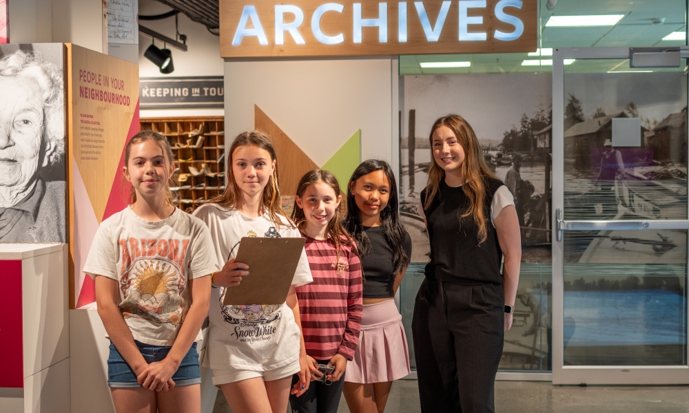 Students Stand in front of the Archives with Staff