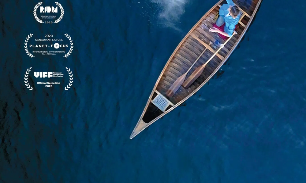 Movie poster for the film the Magnitude of All Things, including an overhead shot of a canoe in a blue body of water.