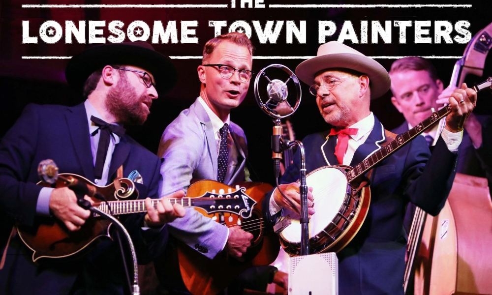 The Lonesome Town painters crowd a microphone with a mandolin, guitars, bass, and banjo.