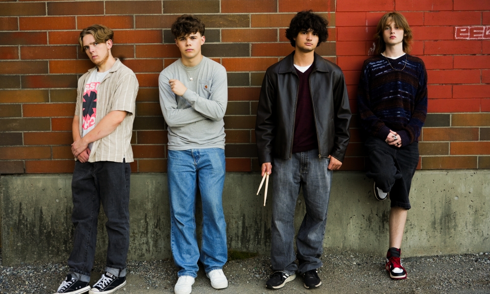 The four members of the Ziltches stand in front of a brick wall. 