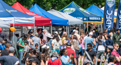 A crowd gathers at booths around the North Delta Market. 