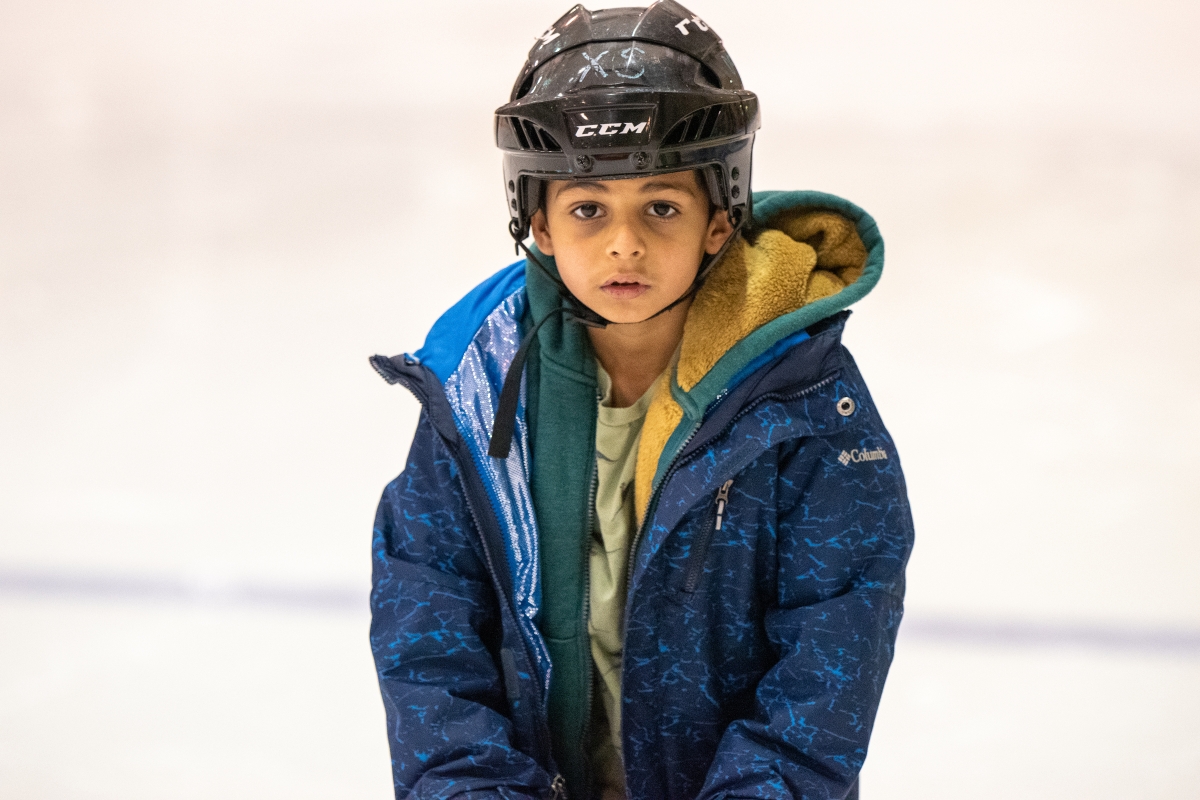 A new skating student experiences the ice for the first time. 