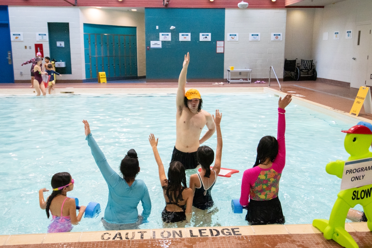 Students in the teach pool at Sungod listen to their instructor.