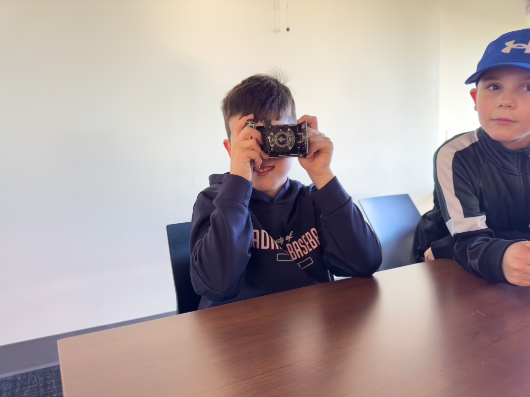 Student plays with a camera from the archives.