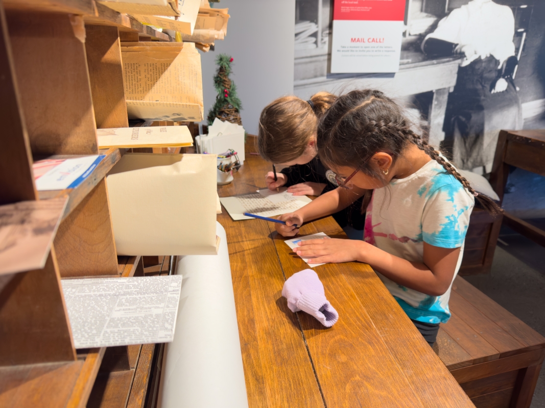 Students write letters outside the Archives