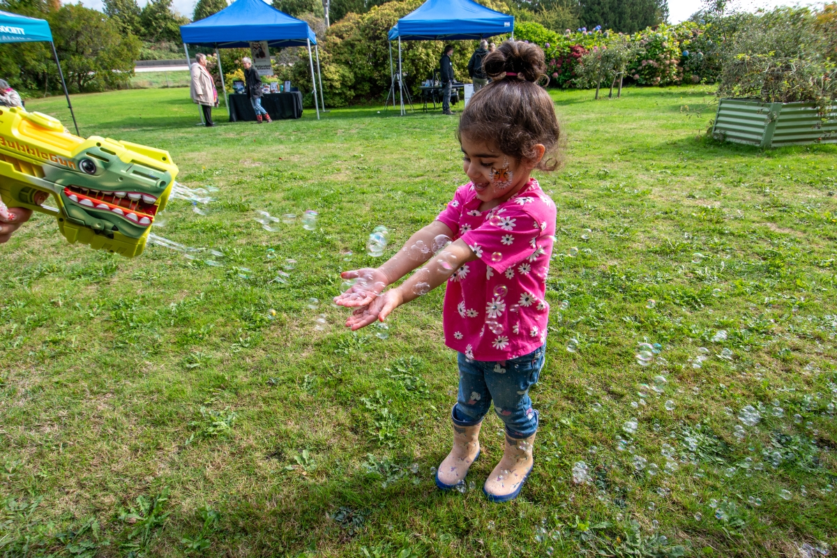 A visitor enjoys her time playing in the Discovery Centre Orchard!