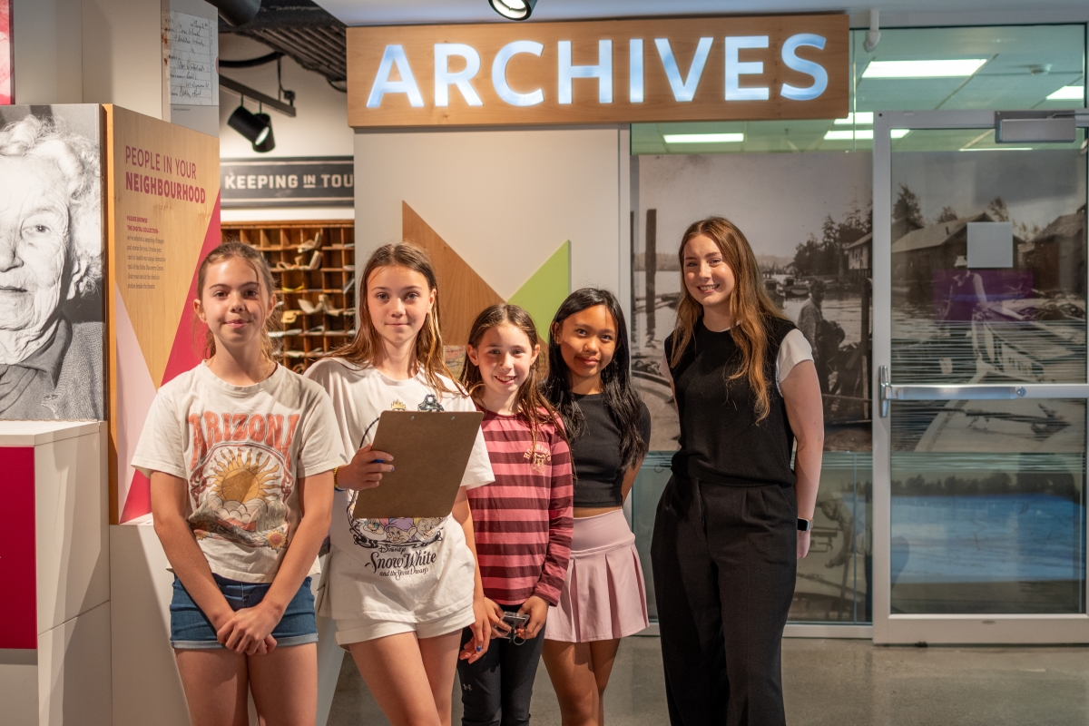 Students Stand in front of the Archives with Staff
