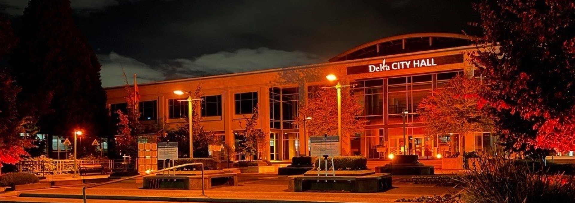 Delta Municipal Hall lit in orange