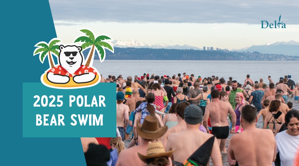A crowd of bathing-suit clad swimmer head into Boundary Bay on January 1.