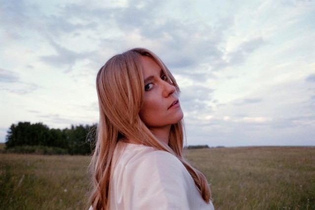 Photo of Carly Reirson in a field.