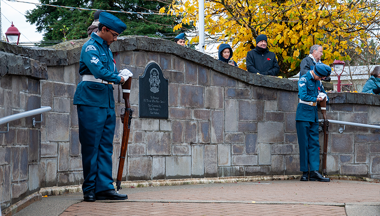 People pay respects outside the North Delta Recreation Centre for the Remembrance Day Ceremony.