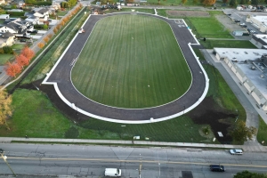 Overhead daytime drone shot of the newly asphalted track at Delta Secondary School. 