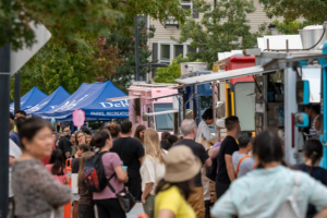 People lined up at food trucks at the Luminary Festival.